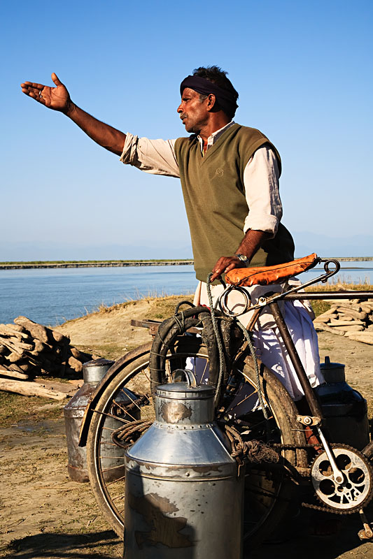  Farmers bringing ther milk cans to a distirbution point at the shore of the Brahmaputra river